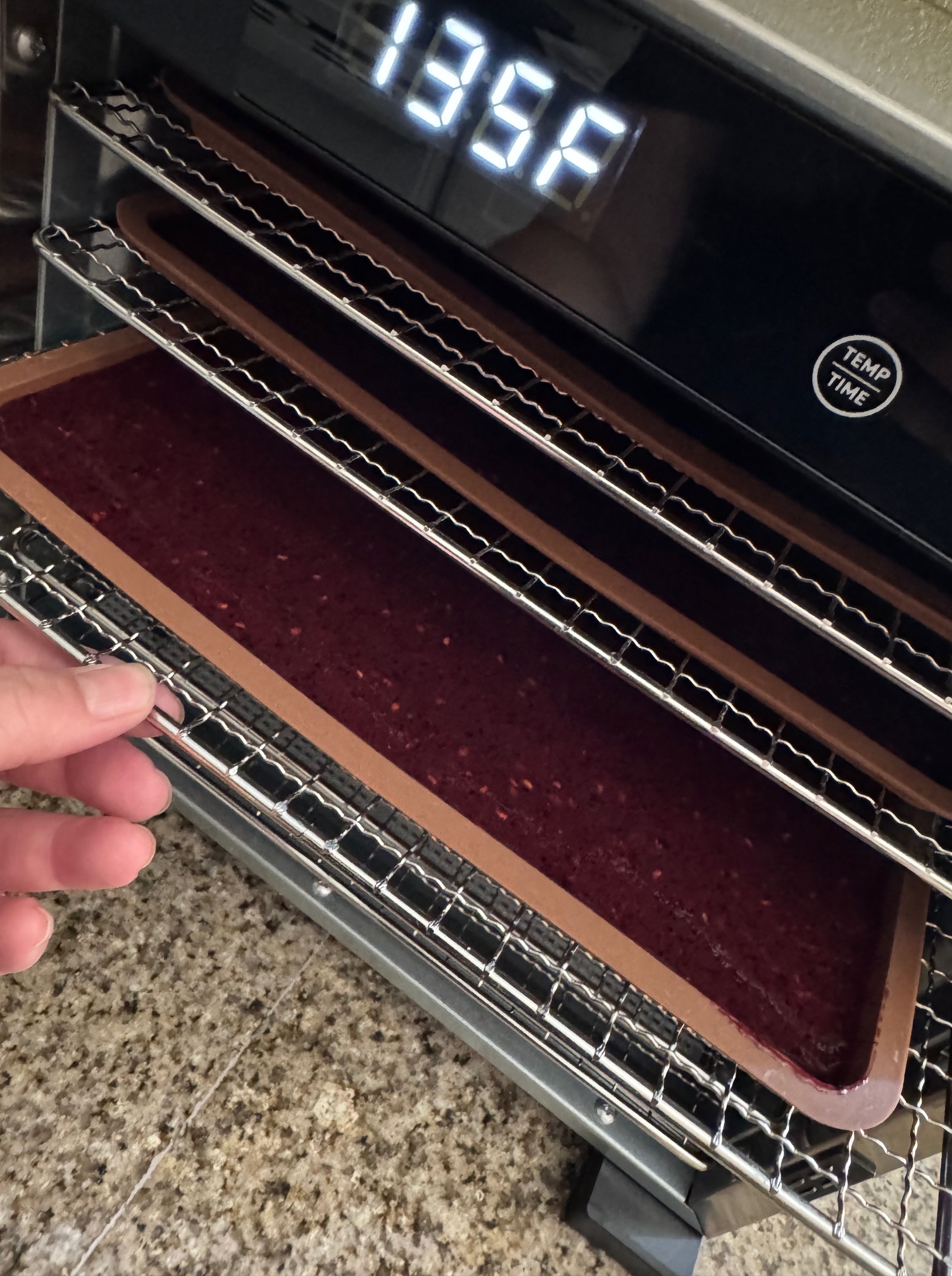 Checking food in a dehydrator